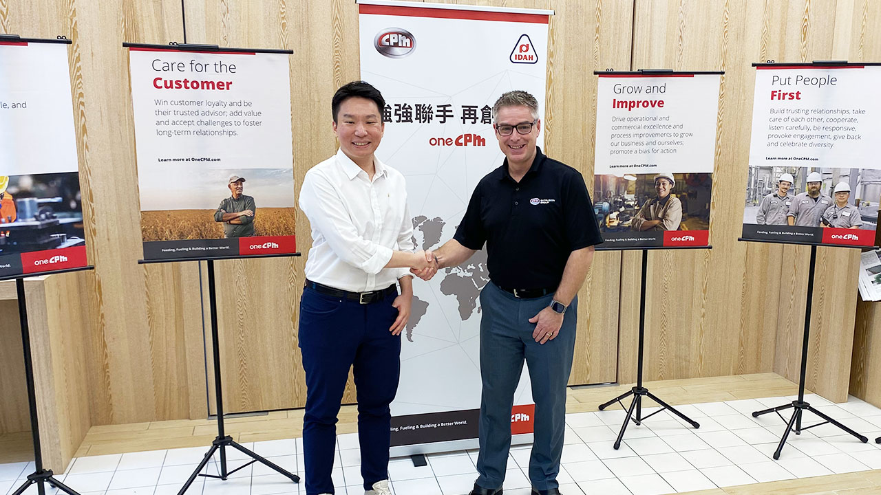 Danny Chang, General Manager, IDAH, and Charlie Spearing, General Manager, CPM Process Solutions, shaking hands