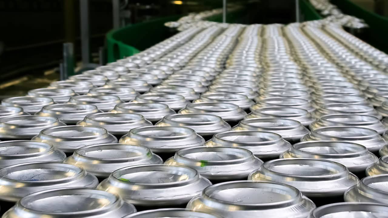 Hundreds of aluminum cans on a conveyor belt